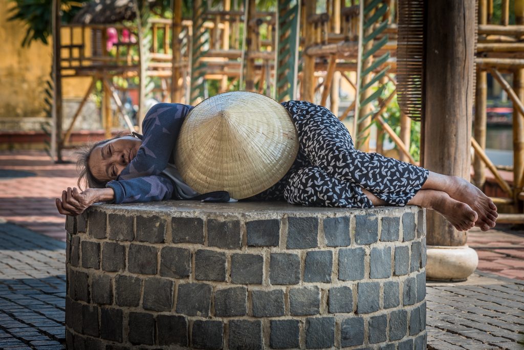 Vietnamese woman sleeping with hat